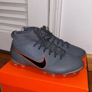 Nike Charcoal Cleats with Vibrant Orange Logo